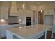 Bright kitchen featuring a large island, modern white cabinets, and stainless steel appliances at 1619 Tielman Way, Snellville, GA 30078
