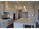 Bright kitchen featuring a large island, modern white cabinets, and stainless steel appliances at 1619 Tielman Way, Snellville, GA 30078