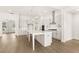 Bright kitchen with stainless steel appliances, expansive island, and open view into the living areas at 1619 Tielman Way, Snellville, GA 30078