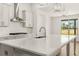 Bright kitchen featuring a large kitchen island, modern cabinets, and a stainless steel range hood at 1619 Tielman Way, Snellville, GA 30078