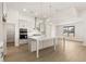 Open kitchen with large island, stainless appliances, white cabinets, and pendant lighting at 1619 Tielman Way, Snellville, GA 30078