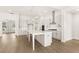 Open kitchen with large island, stainless appliances, white cabinets, and pendant lighting at 1619 Tielman Way, Snellville, GA 30078