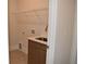 Laundry room featuring a sink, brown cabinets, and wire shelving at 1619 Tielman Way, Snellville, GA 30078