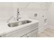 Laundry room includes a stainless steel sink and neutral countertops at 1619 Tielman Way, Snellville, GA 30078