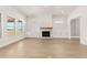 Spacious living room featuring a stone fireplace, built-in cabinets and lots of natural light at 1619 Tielman Way, Snellville, GA 30078