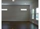 Bright room with dark wood floors, white trim, recessed lights and large windows at 1619 Tielman Way, Snellville, GA 30078