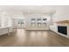 Open living room with a stone fireplace, hardwood floors, and an eat-in kitchen at 1619 Tielman Way, Snellville, GA 30078