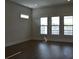 Living room with dark wood floors, white trim, and ample natural light at 1619 Tielman Way, Snellville, GA 30078