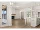 Open-concept living space with a modern fireplace, built-in cabinets, and view into the kitchen at 1619 Tielman Way, Snellville, GA 30078