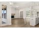 Open-concept living space connecting kitchen with island to living room with fireplace at 1619 Tielman Way, Snellville, GA 30078