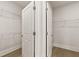 Bright walk-in closet with ample shelving and a double door entry at 1619 Tielman Way, Snellville, GA 30078