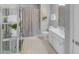 Bright bathroom offers dual sinks, white cabinets, a glass enclosed shower, and a chrome storage unit at 195 Mystic Ct, Atlanta, GA 30342