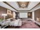 A bedroom featuring a chandelier, tray ceiling, and a plush carpet for added comfort at 195 Mystic Ct, Atlanta, GA 30342