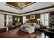 A bedroom featuring a chandelier, tray ceiling, and a plush carpet for added comfort at 195 Mystic Ct, Atlanta, GA 30342