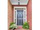 Welcoming front entrance with a classic black door, sidelights, and decorative plants at 195 Mystic Ct, Atlanta, GA 30342