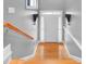 Bright hallway featuring hardwood steps, white trim, and elegant wall sconces at 195 Mystic Ct, Atlanta, GA 30342