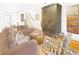 Comfortable living room with hardwood floors, brown couches, and a striking armoire and staircase at 195 Mystic Ct, Atlanta, GA 30342