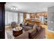 Bright living room featuring hardwood floors, a modern light fixture, and an eat-in kitchen at 195 Mystic Ct, Atlanta, GA 30342