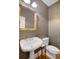 Stylish powder room with elegant mirror, patterned wallpaper, and classic fixtures at 195 Mystic Ct, Atlanta, GA 30342