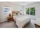 Cozy bedroom featuring a wooden bed frame, neutral tones, and natural light from two windows at 2059 Wheaton Way, Atlanta, GA 30328