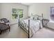 Bright bedroom featuring a decorative metal frame bed, neutral carpet and furnishings at 2059 Wheaton Way, Atlanta, GA 30328
