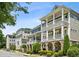 Beautiful multi-story homes featuring stacked porches, stone accents, and manicured landscaping at 2059 Wheaton Way, Atlanta, GA 30328