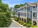 Townhomes with screened porches, showcasing a community with mature landscaping and architectural details at 2059 Wheaton Way, Atlanta, GA 30328