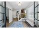 Bright foyer featuring wood floors, barn door accent, and a staircase to the upper level at 2059 Wheaton Way, Atlanta, GA 30328