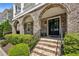 Inviting front entrance with brick arches, double doors, and well-manicured shrubbery at 2059 Wheaton Way, Atlanta, GA 30328