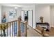 Upstairs hallway featuring wood floors, white walls, and views of the front entryway at 2059 Wheaton Way, Atlanta, GA 30328