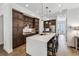 Modern kitchen with a large quartz island, dark wood cabinets, and stainless steel appliances at 2059 Wheaton Way, Atlanta, GA 30328