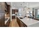 Bright kitchen features custom cabinets, stainless appliances, and island with quartz countertops at 2059 Wheaton Way, Atlanta, GA 30328