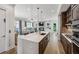 Modern kitchen and open living space with large center island and stainless steel appliances at 2059 Wheaton Way, Atlanta, GA 30328