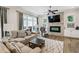 Comfortable living room featuring a fireplace, ceiling fan, and ample natural light at 2059 Wheaton Way, Atlanta, GA 30328