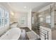 Luxurious primary bathroom featuring a soaking tub and tiled glass shower at 2059 Wheaton Way, Atlanta, GA 30328