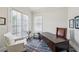 Sunlit home office with a dark wood desk, decorative rug, and comfortable seating at 2059 Wheaton Way, Atlanta, GA 30328