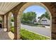 View of the street seen through brick arches and lush greenery, showcasing the charming neighborhood at 2059 Wheaton Way, Atlanta, GA 30328