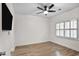 Bedroom with wood flooring, white walls, a ceiling fan and window with white shutters at 2983 Crosswycke Forest Dr, Brookhaven, GA 30319
