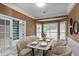 Elegant dining room with seating for eight, stylish wallpaper, and French doors at 2983 Crosswycke Forest Dr, Brookhaven, GA 30319