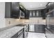 Modern kitchen featuring stainless steel appliances, dark cabinetry and granite countertops at 2983 Crosswycke Forest Dr, Brookhaven, GA 30319