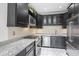 Modern kitchen with black cabinetry, stainless steel appliances, and granite countertops at 2983 Crosswycke Forest Dr, Brookhaven, GA 30319