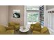 Cozy sitting room features comfortable armchairs, a round table, and custom built-in bookshelves at 2983 Crosswycke Forest Dr, Brookhaven, GA 30319