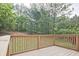 There is a wooden deck that overlooks a lawn and treeline at 87 Davis Mill Ct, Lawrenceville, GA 30044