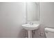 Clean bathroom featuring a modern pedestal sink and tiled floors, providing a simple design at 87 Davis Mill Ct, Lawrenceville, GA 30044