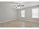 Bedroom features hardwood floors, neutral walls, and two windows at 87 Davis Mill Ct, Lawrenceville, GA 30044