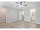 Bright bedroom boasts hardwood floors, fan, ensuite bathroom, and walk-in closet at 87 Davis Mill Ct, Lawrenceville, GA 30044