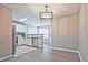 Open-concept dining area with hardwood floors and modern lighting, flowing into the kitchen at 87 Davis Mill Ct, Lawrenceville, GA 30044