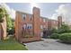 Brick townhouses with concrete front parking pads at 87 Davis Mill Ct, Lawrenceville, GA 30044