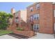 Charming brick townhouse with tidy landscaping and a cozy, welcoming entrance with iron railings and stairs at 87 Davis Mill Ct, Lawrenceville, GA 30044
