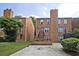 Exterior view of brick townhouse with front parking pad at 87 Davis Mill Ct, Lawrenceville, GA 30044